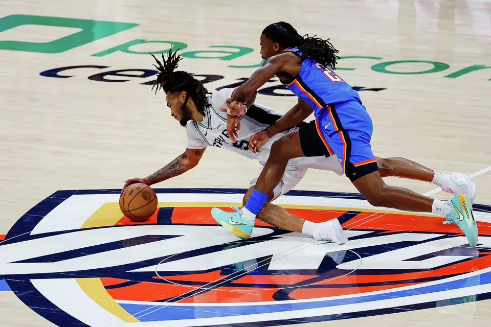 San Antonio Spurs guard Stephon Castle (5) and Oklahoma City Thunder guard Cason Wallace (22) fall to the court while going after the ball during the fourth quarter of Game 2 of the Western Conference Finals at Paycom Center in Oklahoma City, Wednesday, May 20, 2026. The San Antonio Spurs fell 122-113 to the Oklahoma City Thunder.