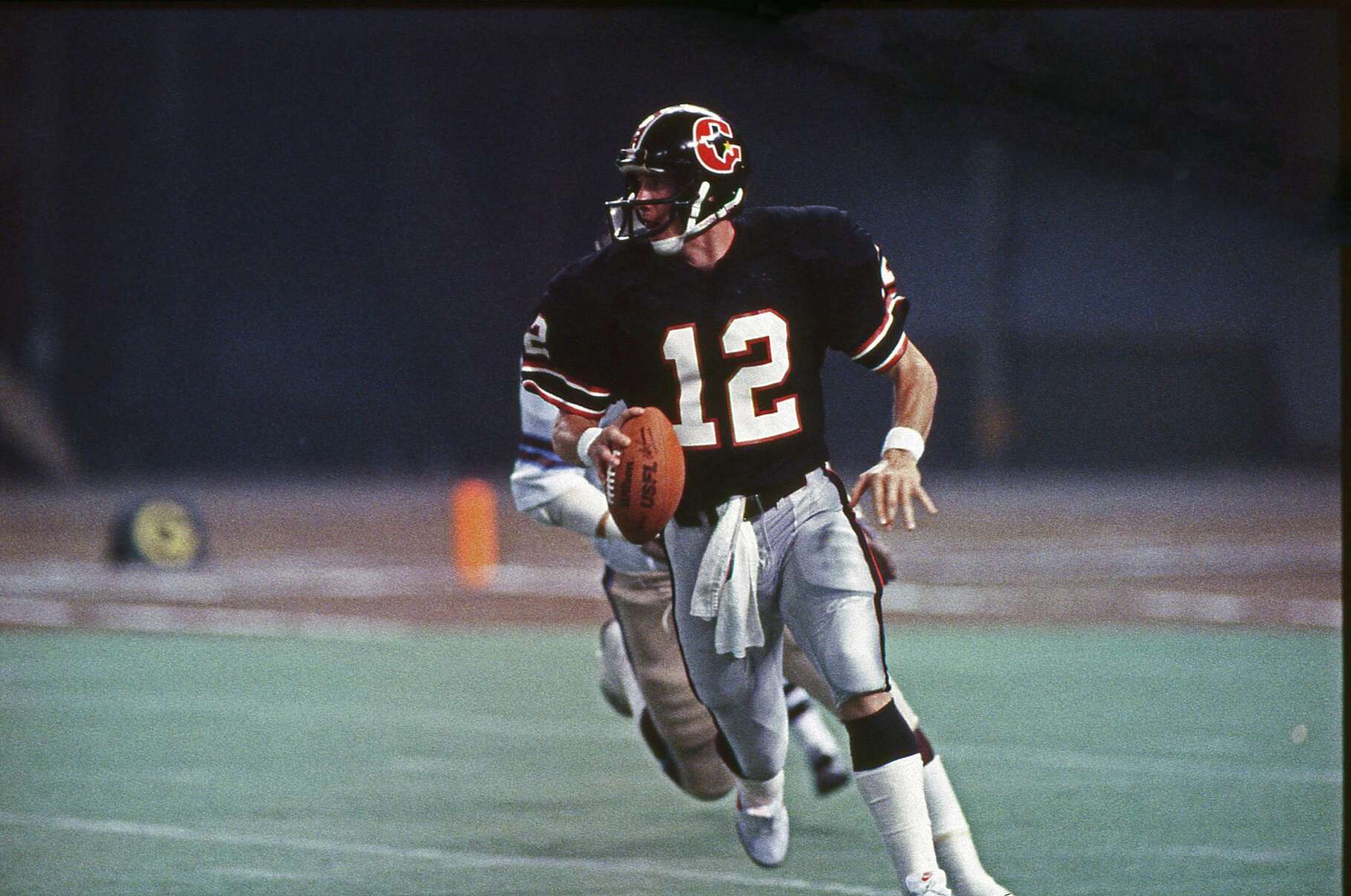 03/26/1984 - Houston Gamblers v Michigan Panthers. Gamblers quarterback Jim Kelly (12) looking downfield