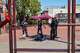 Mission Station police Capt. Sean Perdomo, right, talks with a man who was selling items at Mission and 24th streets.