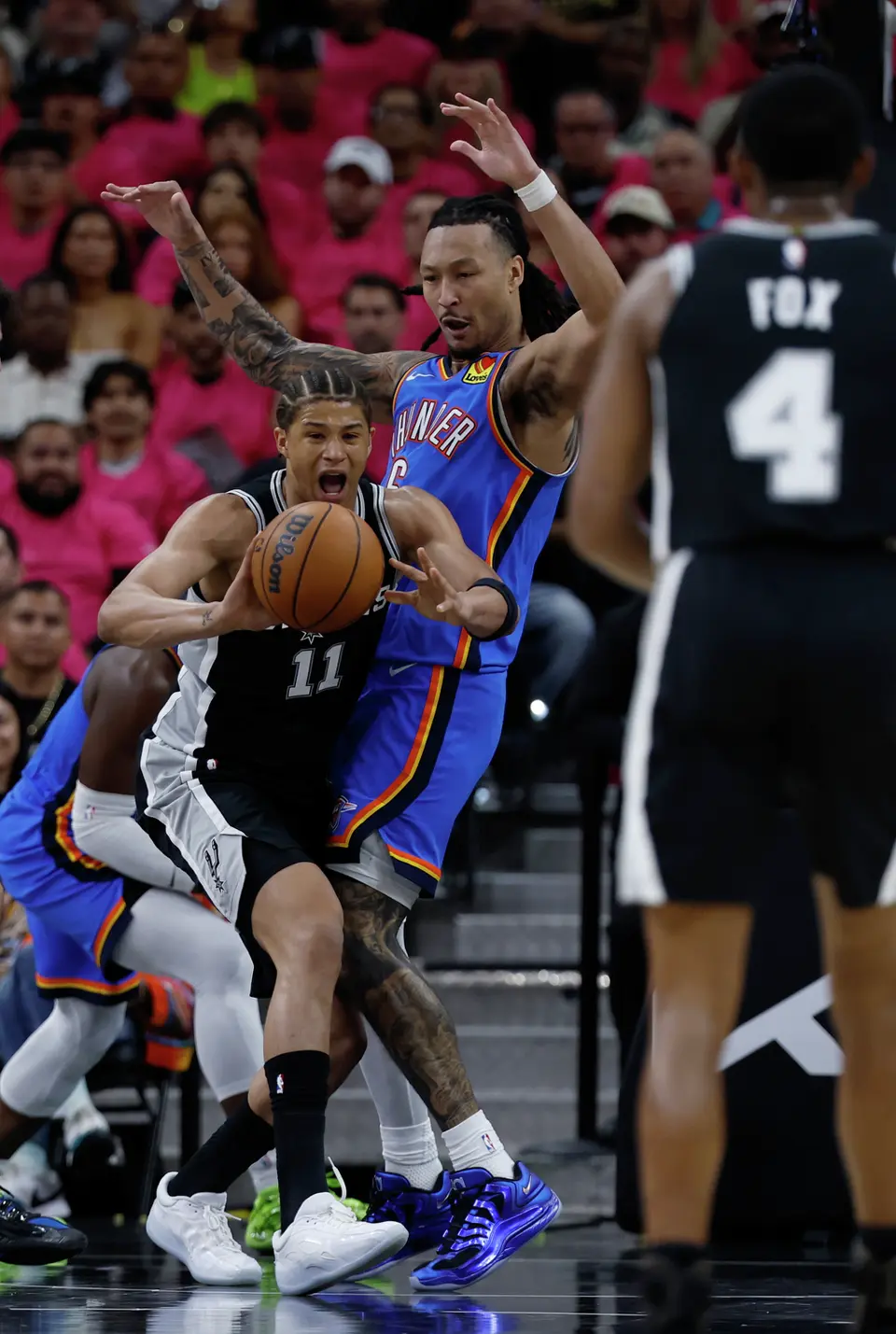 San Antonio Spurs forward Carter Bryant (11) passes the ball off to San Antonio Spurs guard De'Aaron Fox (4) during the first half of Game 3 of the Western Conference Finals at Frost Bank Center in San Antonio, Friday, May 22, 2026.