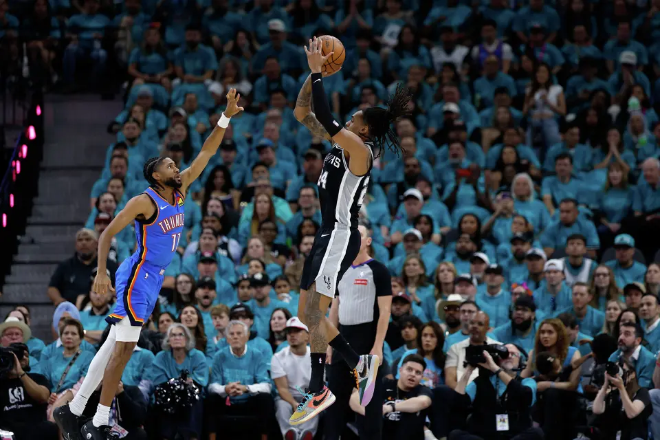 San Antonio Spurs guard Devin Vassell (24) shoots a basket over Oklahoma City Thunder guard Isaiah Joe (11) during the first half of Game 3 of the Western Conference Finals at Frost Bank Center in San Antonio, Friday, May 22, 2026.