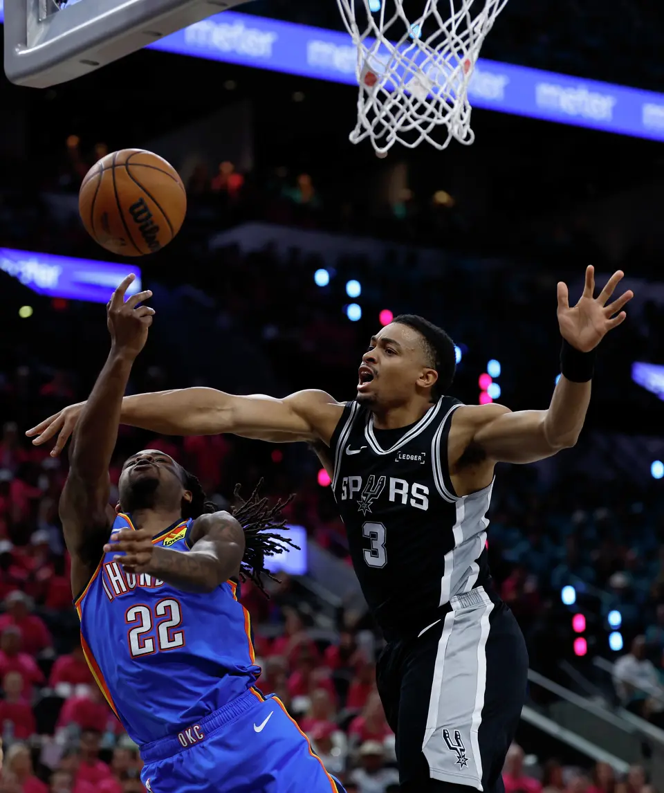 San Antonio Spurs forward Keldon Johnson (3) blocks the shot of Oklahoma City Thunder guard Cason Wallace (22) during the first half of Game 3 of the Western Conference Finals at Frost Bank Center in San Antonio, Friday, May 22, 2026.