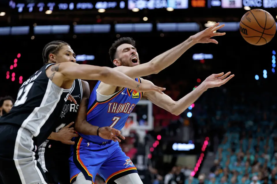 San Antonio Spurs forward Carter Bryant (11) knocks the ball away from Oklahoma City Thunder center Chet Holmgren (7) during the first half of Game 3 of the Western Conference Finals at Frost Bank Center in San Antonio, Friday, May 22, 2026.