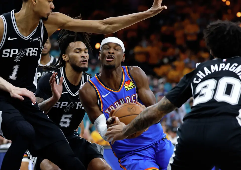 Oklahoma City Thunder guard Shai Gilgeous-Alexander (2) tries to take the ball app the middle through a thick Spurs defense during the first half of Game 3 of the Western Conference Finals at Frost Bank Center in San Antonio, Friday, May 22, 2026.