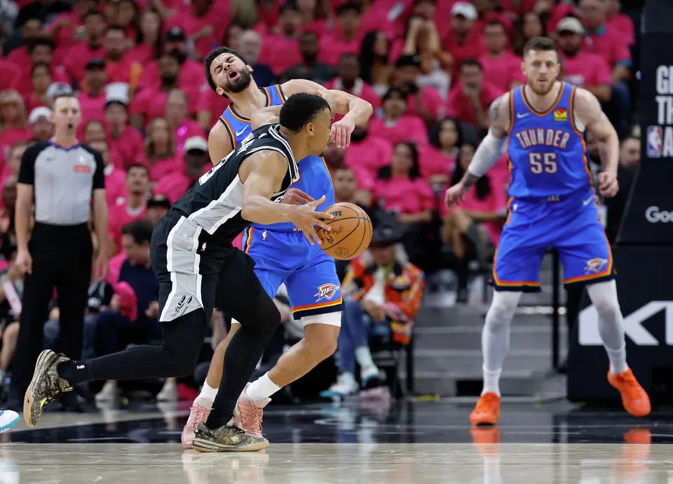 Oklahoma City Thunder guard Ajay Mitchell (25) takes a shot to the face from San Antonio Spurs forward Keldon Johnson (3) during the first half of Game 3 of the Western Conference Finals at Frost Bank Center in San Antonio, Friday, May 22, 2026.