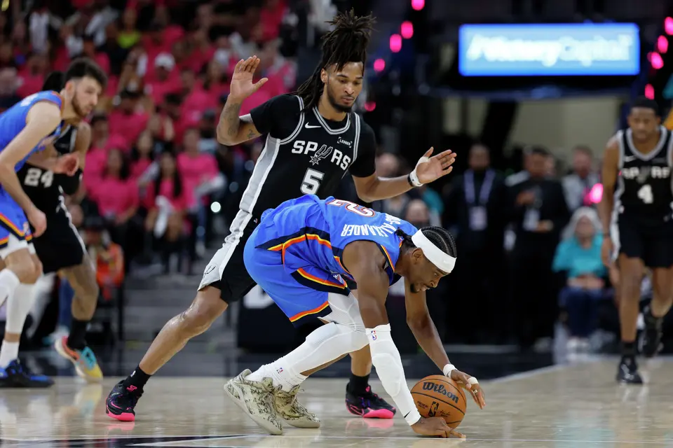 Oklahoma City Thunder guard Shai Gilgeous-Alexander (2) looses his balance while being guarded by San Antonio Spurs guard Stephon Castle (5) during the third quarter of Game 3 of the Western Conference Finals at Frost Bank Center in San Antonio, Friday, May 22, 2026.