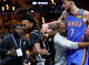San Antonio Spurs guard Stephon Castle (5) and Oklahoma City Thunder center Chet Holmgren (7) are restrained by NBA staff after a foul on Castle by Oklahoma City Thunder guard Ajay Mitchell (25) during the third quarter of Game 3 of the Western Conference Finals at Frost Bank Center in San Antonio, Friday, May 22, 2026.
