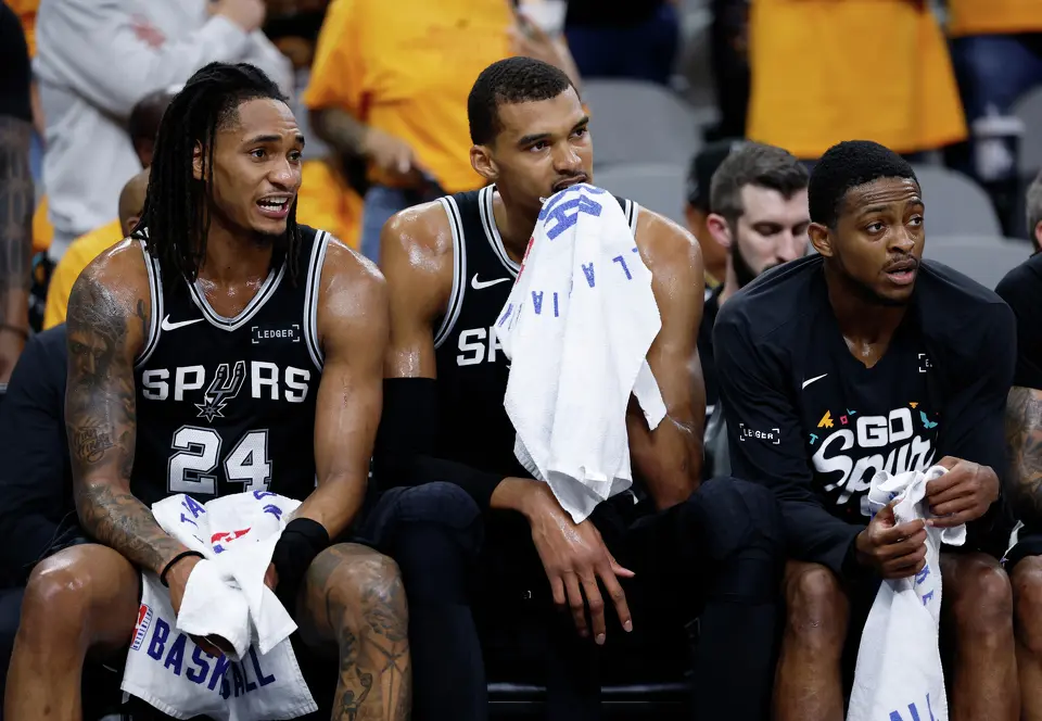 San Antonio Spurs guard Devin Vassell (24), forward Victor Wembanyama (1) and guard De'Aaron Fox (4) watch the game action during the 4th quarter of Game 3 in the Western Conference Finals at Frost Bank Center in San Antonio, Friday, May 22, 2026. The Spurs fell 123-108 to the Thunder, who now lead the series 2-1.