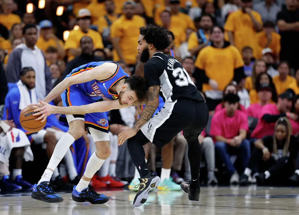 Oklahoma City Thunder center Chet Holmgren (7) lowers his shoulder as he tries to drive to the basket past San Antonio Spurs forward Julian Champagnie (30) during the second half of Game 3 of the Western Conference Finals at Frost Bank Center in San Antonio, Friday, May 22, 2026. The Spurs fell 123-108 to the Thunder, who now lead the series 2-1.