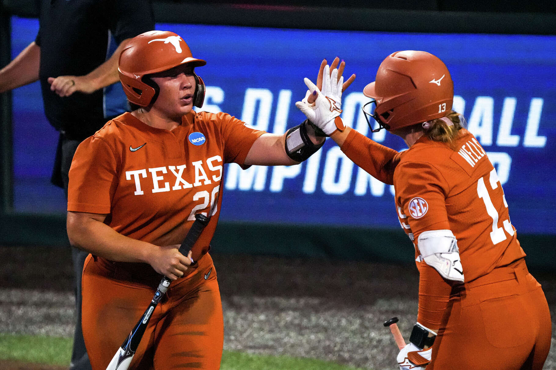 Texas Longhorns designated player Hannah Wells (13) celebrates a score by infielder Katie Stewart (20) during the NCAA Softball Championship Super Regional against Arizona State at Red & Charline McCombs Field on Saturday, May 23, 2026 in Austin.