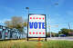 A "VOTE" sign is posted near a polling center in Austin. Texans head to the polls Tuesday to decide races for the Senate and other statewide and local offices.
