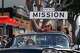 A woman holds up a “Made in the Mission” street sign during the 48th annual Carnaval San Francisco parade.