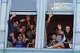 Bystanders wave out the window during the 48th annual Carnaval San Francisco parade on 24th Street.