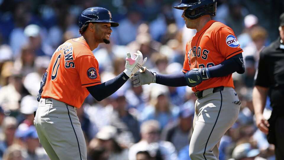 Houston Astros' Nick Allen, right, celebrates with teammate Brice Matthews (0) after hitting a solo home run during the third inning of a baseball game against the Chicago Cubs in Chicago, Sunday, May 24, 2026. (AP Photo/Paul Beaty)