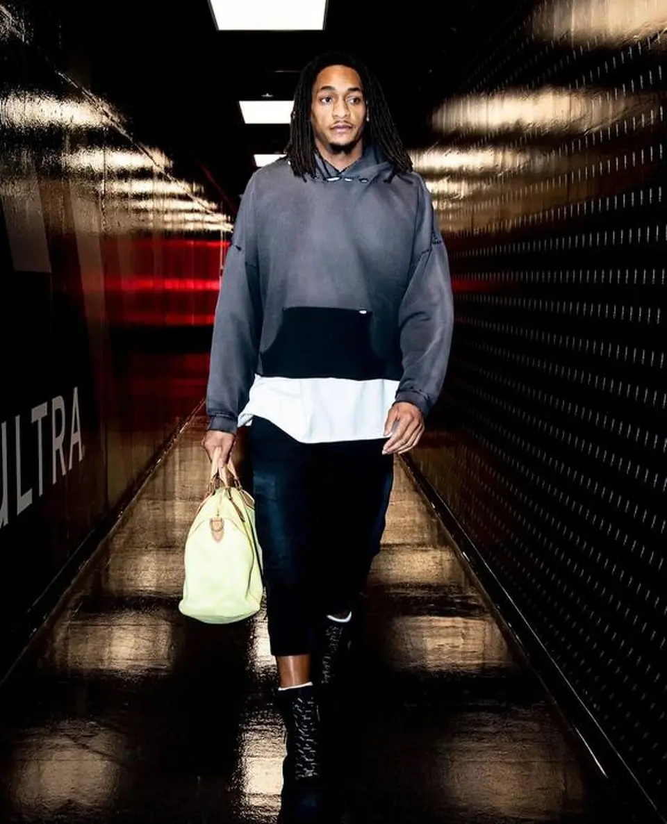 The Spurs' Devin Vassell arrives carrying a Louis Vuitton travel bag before Game 4 of the Western Conference finals against the Oklahoma City Thunder at Frost Bank Center.