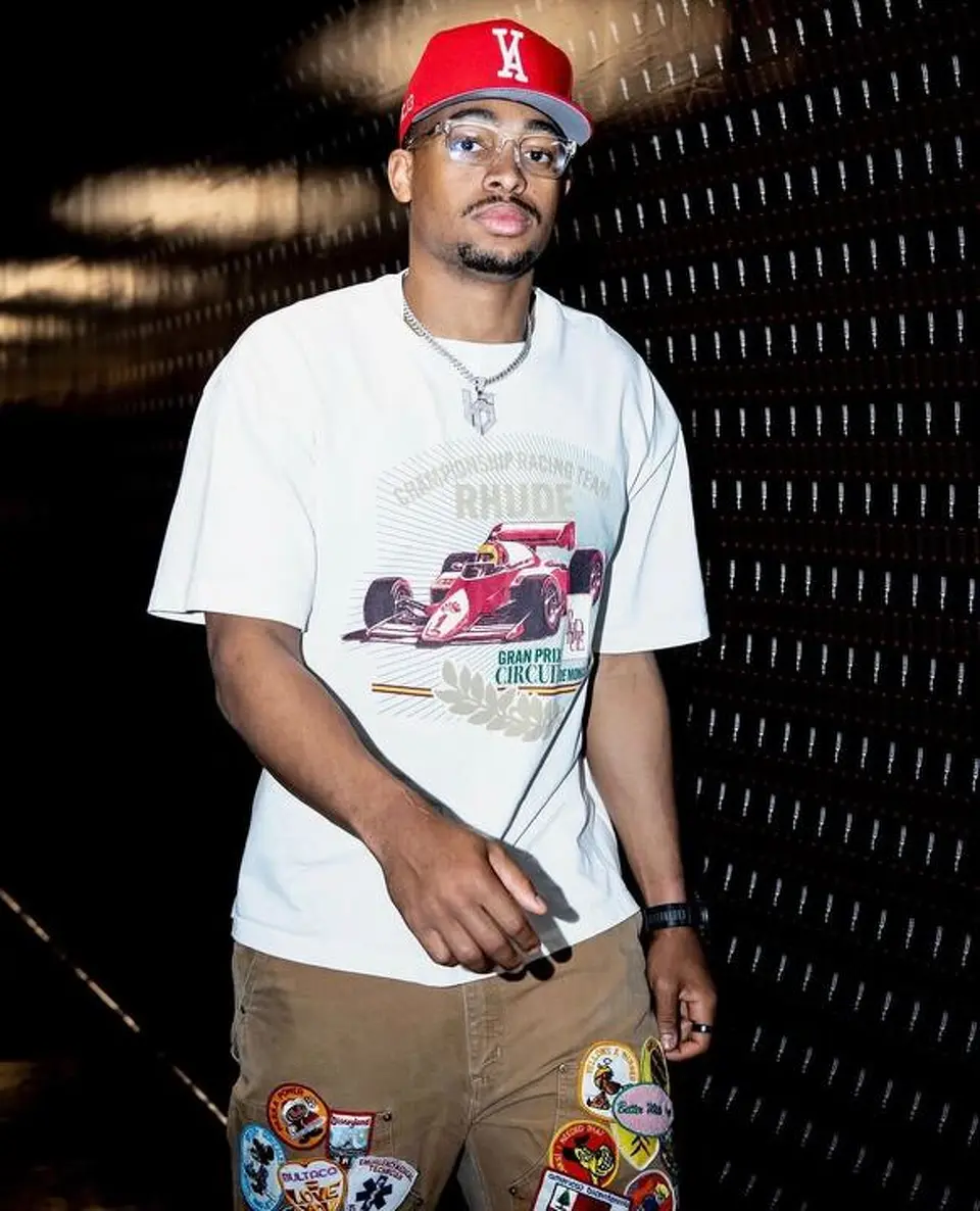 Keldon Johnson arrives at Frost Bank Center wearing a Rhude racing graphic T-shirt ahead of Game 4 against the Oklahoma City Thunder.