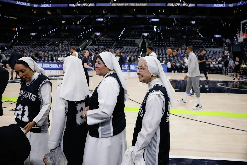 Salesian Sisters of St. John Bosco walk by the court where members of the San Antonio Spurs warm up before Game 4 of the Western Conference Finals against the Oklahoma City Thunder at Frost Bank Center in San Antonio, Sunday, May 24, 2026.