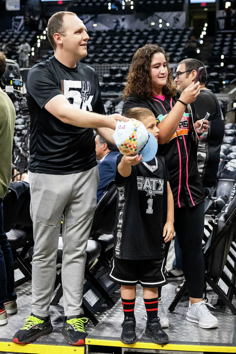 Kyle and Rita Willman stand with their son Ezra Willman, 5, while waiting for players prior to the start of Game 4 of the Western Conference Finals at Frost Bank Center in San Antonio on Sunday, May 24, 2026.