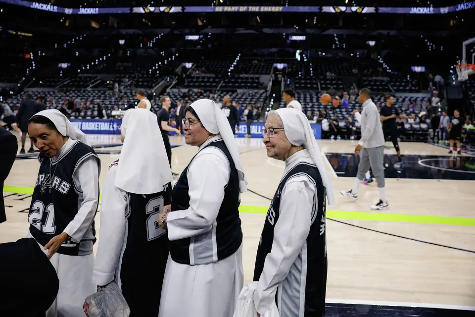 Salesian Sisters of St. John Bosco walk by the court where members of the San Antonio Spurs warm up before Game 4 of the Western Conference Finals against the Oklahoma City Thunder at Frost Bank Center in San Antonio, Sunday, May 24, 2026.