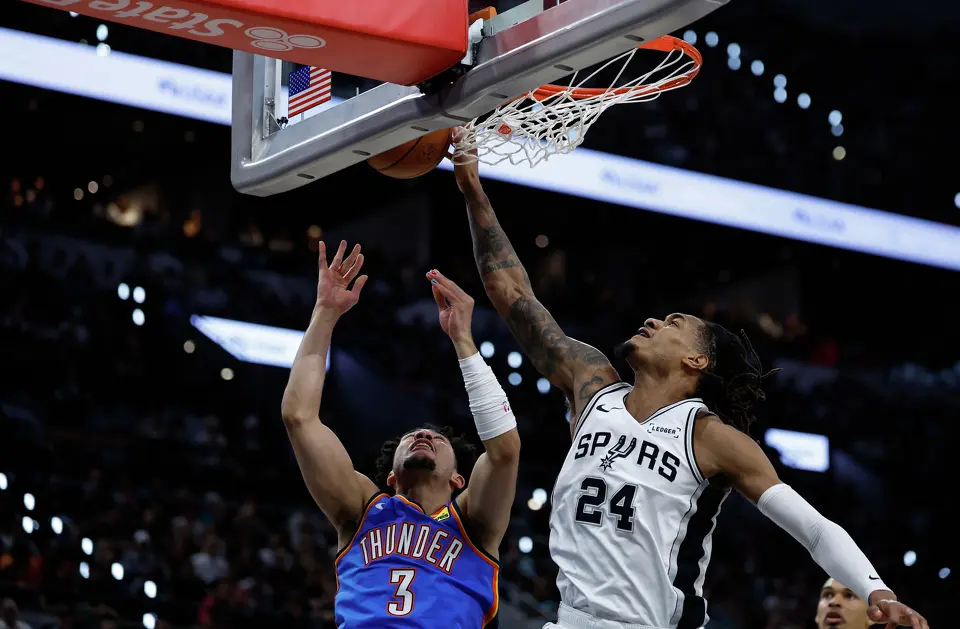 San Antonio Spurs guard Devin Vassell (24) blocks the shot of Oklahoma City Thunder guard Jared McCain (3) during the first quarter of Game 4 of the Western Conference Finals at Frost Bank Center in San Antonio, Sunday, May 24, 2026.