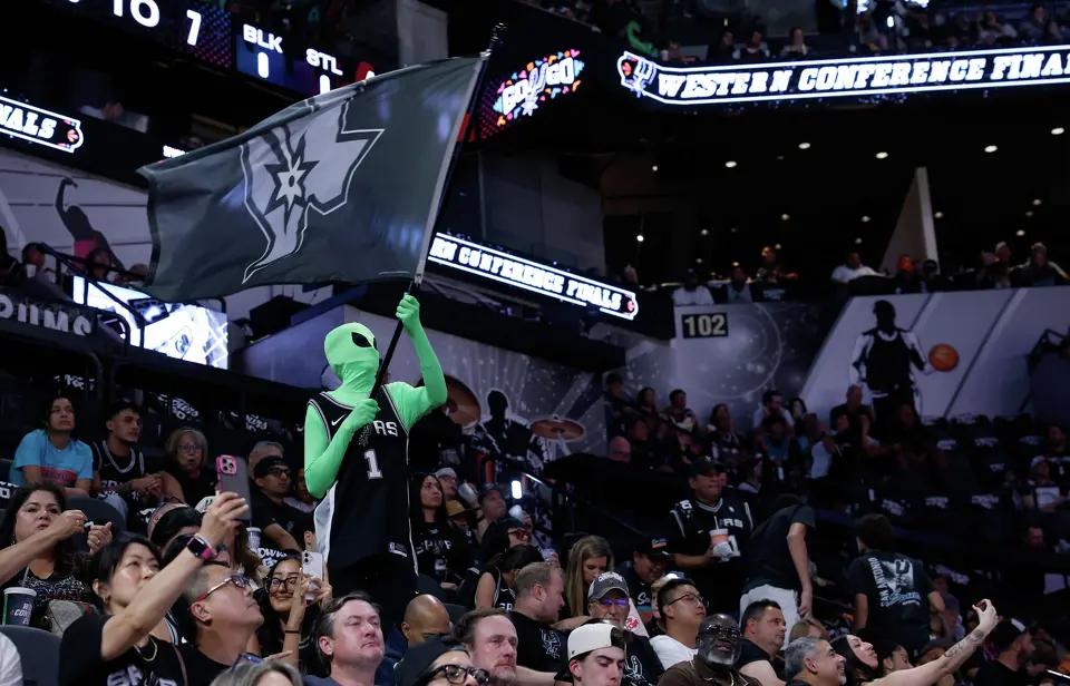 A fan dressed as an alien waves a Spurs flag during the first quarter of Game 4 of the Western Conference Finals at Frost Bank Center in San Antonio, Sunday, May 24, 2026.