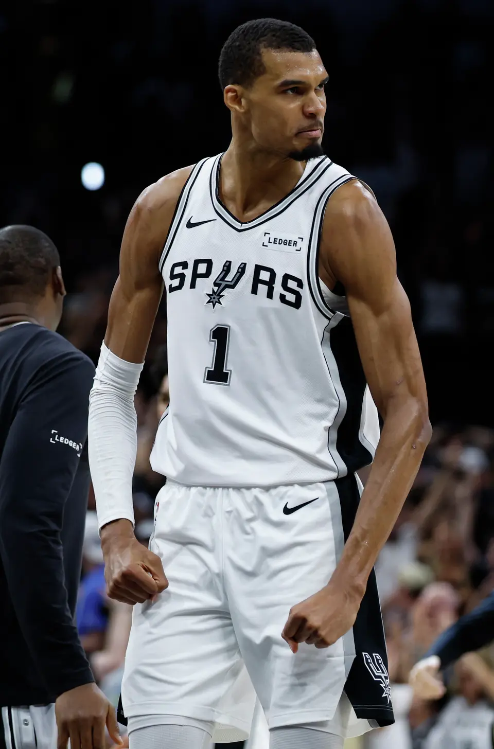 San Antonio Spurs forward Victor Wembanyama (1) flexes after making a three point shot at the buzzer to end the second quarter of Game 4 of the Western Conference Finals at Frost Bank Center in San Antonio, Sunday, May 24, 2026.