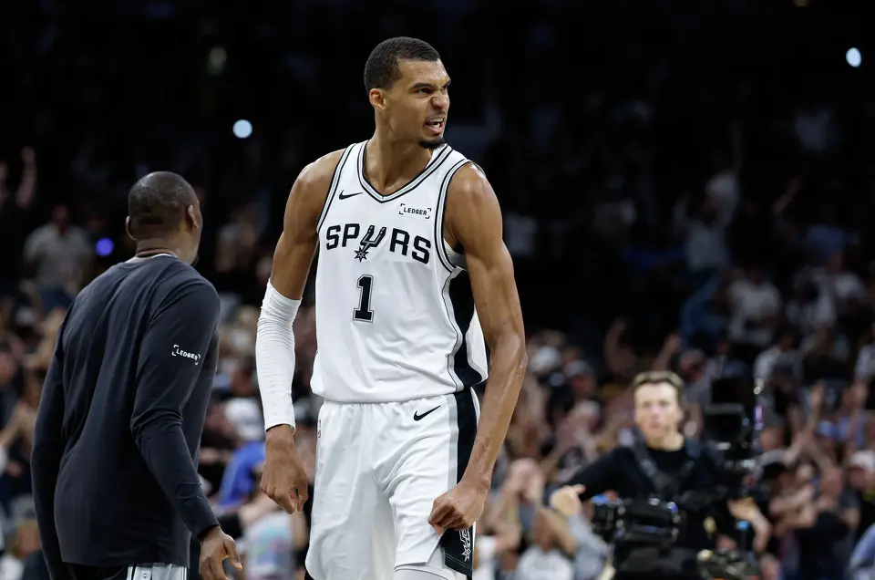 San Antonio Spurs center Victor Wembanyama flexes after making a three-point shot at the buzzer during Game 4 of the Western Conference Finals at Frost Bank Center in San Antonio. Physical gifts are what let him make the shots. Psychological freedom is what lets him take them.