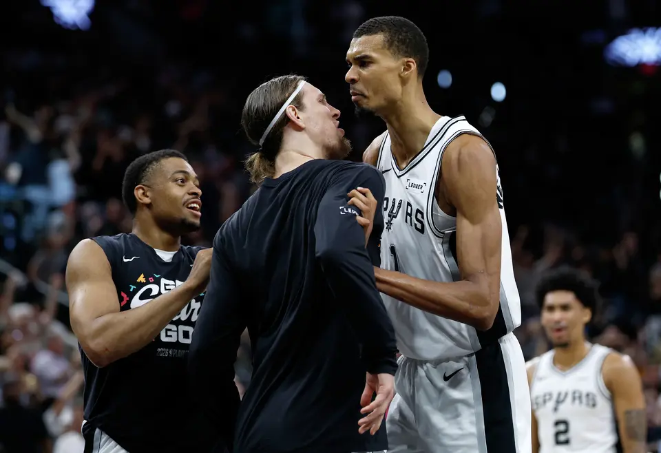 San Antonio Spurs forward Victor Wembanyama (1), San Antonio Spurs forward Kelly Olynyk (8) and San Antonio Spurs forward Keldon Johnson (3) celebrate Wembanyama’s three point shot at the buzzer to end the second quarter of Game 4 of the Western Conference Finals at Frost Bank Center in San Antonio, Sunday, May 24, 2026.