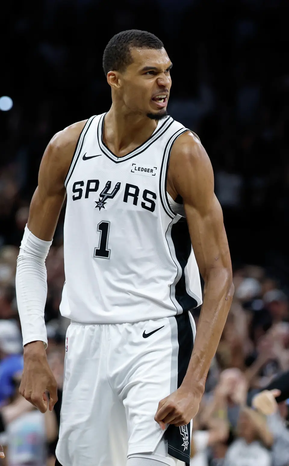 San Antonio Spurs forward Victor Wembanyama (1) flexes after making a three point shot at the buzzer to end the second quarter of Game 4 of the Western Conference Finals at Frost Bank Center in San Antonio, Sunday, May 24, 2026.