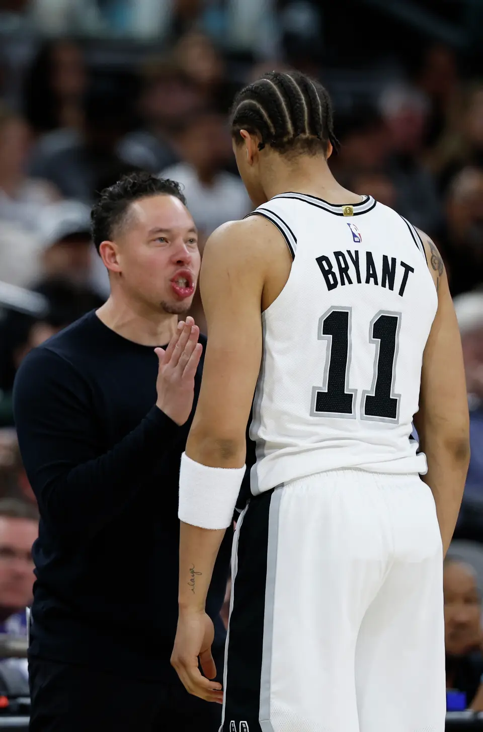 San Antonio Spurs head coach Mitch Johnson gives instructions to San Antonio Spurs forward Carter Bryant (11) during the third quarter of Game 4 of the Western Conference Finals at Frost Bank Center in San Antonio, Sunday, May 24, 2026.