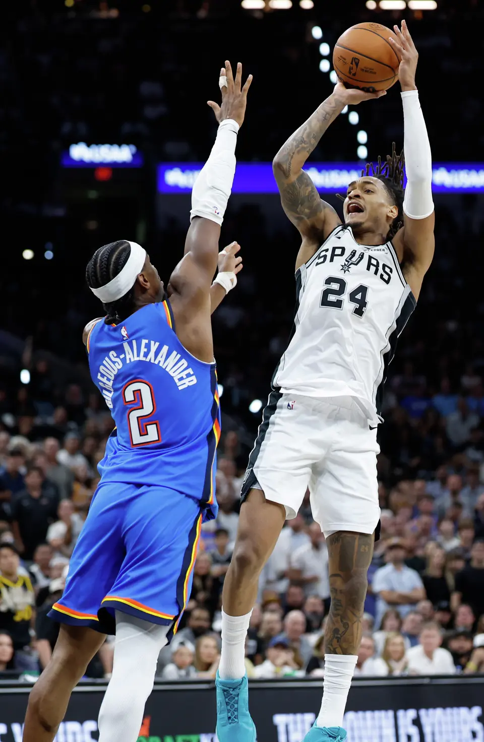San Antonio Spurs guard Devin Vassell (24) pulls up for a jump shot over Oklahoma City Thunder guard Shai Gilgeous-Alexander (2) during the third quarter of Game 4 of the Western Conference Finals at Frost Bank Center in San Antonio, Sunday, May 24, 2026.