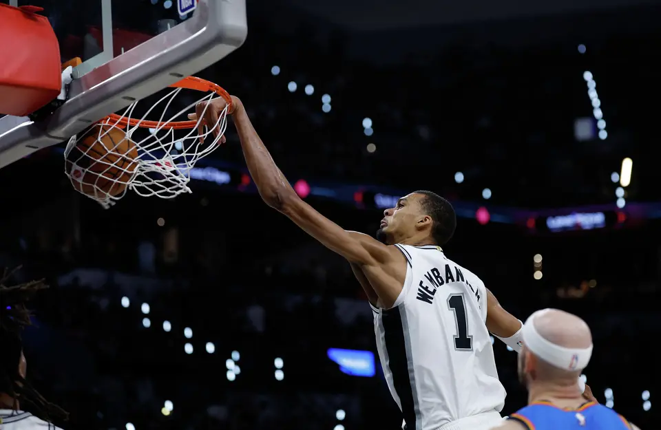 San Antonio Spurs forward Victor Wembanyama (1) makes a slam dunk as Oklahoma City Thunder guard Alex Caruso (9) watchesduring the third quarter of Game 4 of the Western Conference Finals at Frost Bank Center in San Antonio, Sunday, May 24, 2026.
