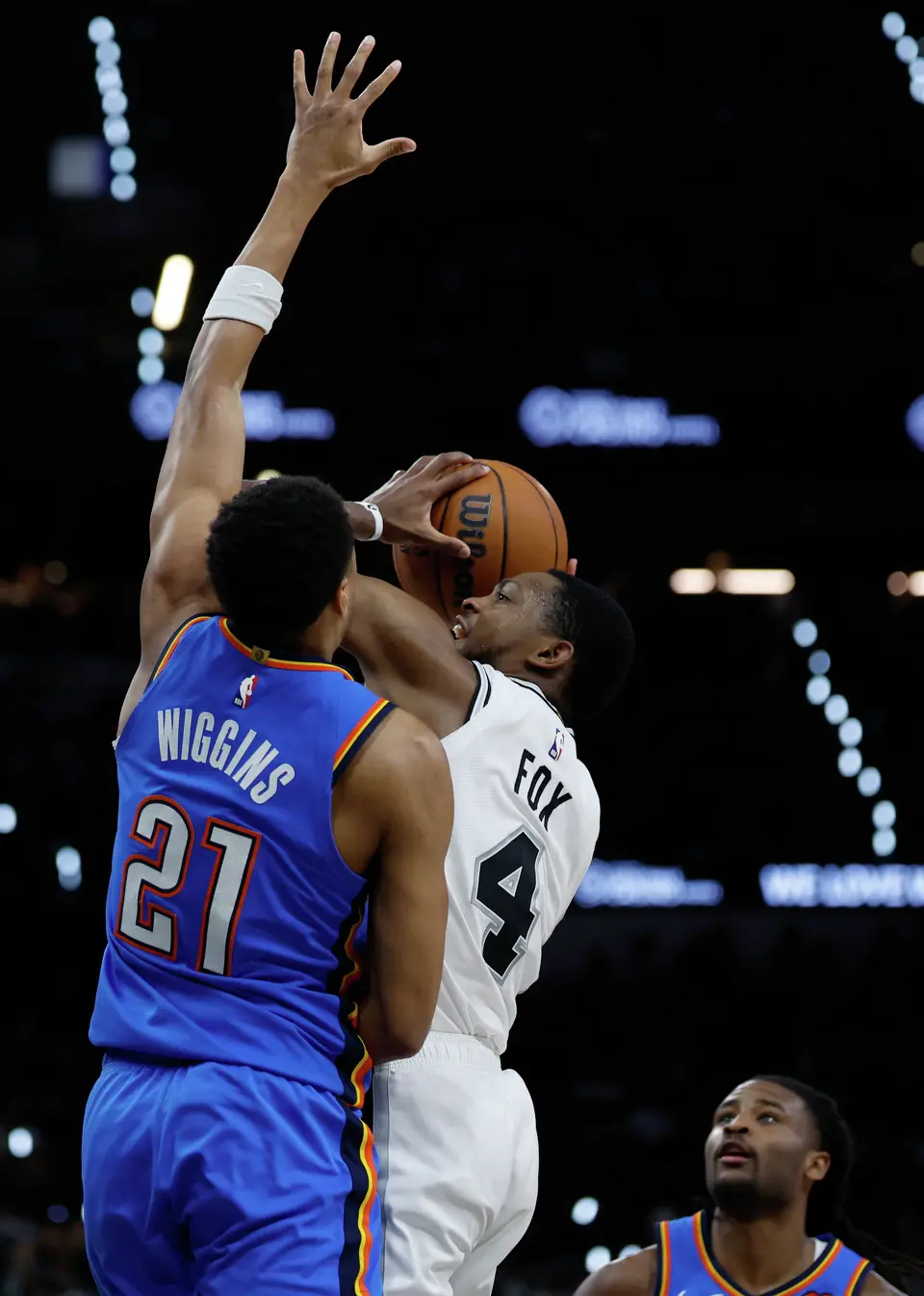 San Antonio Spurs guard De'Aaron Fox (4) tries to make a basket with Oklahoma City Thunder guard Aaron Wiggins (21) attempting to block the shot during the third quarter of Game 4 of the Western Conference Finals at Frost Bank Center in San Antonio, Sunday, May 24, 2026.