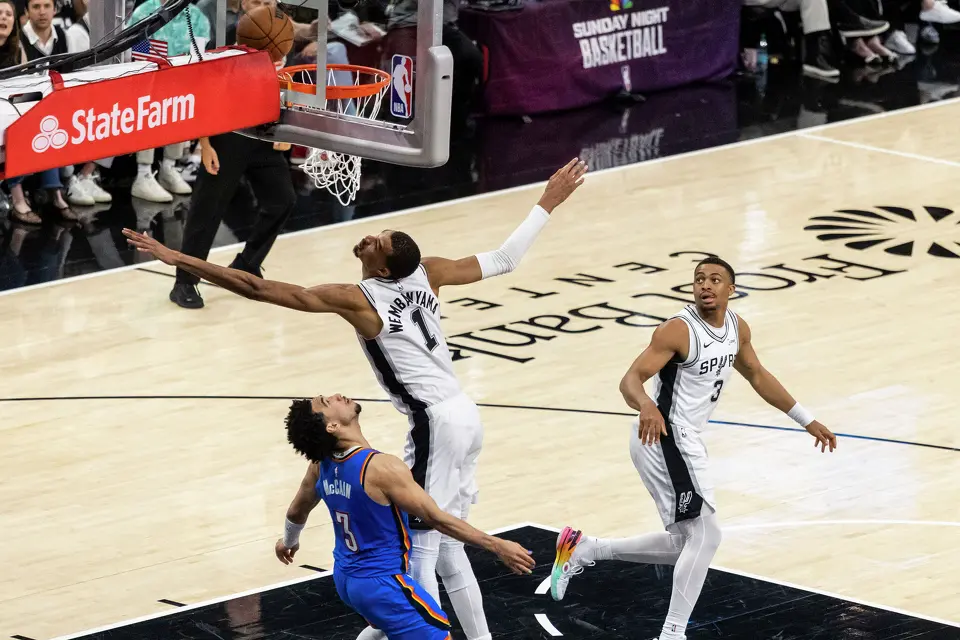 San Antonio Spurs center Victor Wembanyama (1) reaches for the ball near Oklahoma City Thunder guard Jared McCain (3) during Game 4 of the Western Conference Finals at Frost Bank Center in San Antonio on Sunday, May 24, 2026.