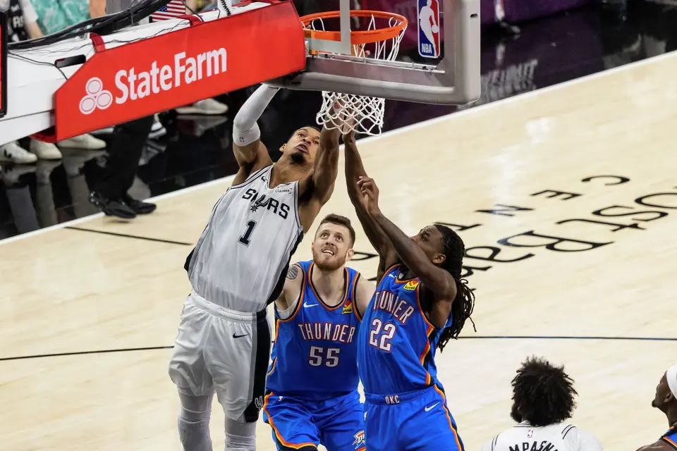 San Antonio Spurs center Victor Wembanyama (1) jumps for the ball above Oklahoma City Thunder center Isaiah Hartenstein (55) and Oklahoma City Thunder guard Cason Wallace (22) during Game 4 of the Western Conference Finals at Frost Bank Center in San Antonio on Sunday, May 24, 2026.