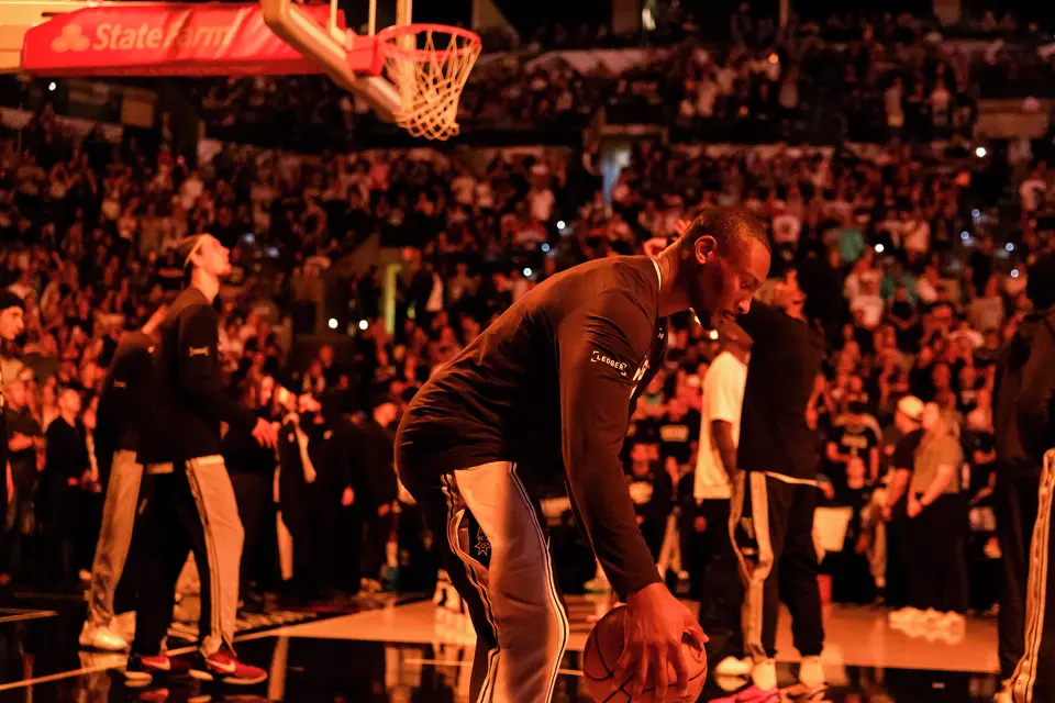 San Antonio Spurs center Bismack Biyombo (18) dribbles the ball before players are introduced during Game 4 of the Western Conference Finals at Frost Bank Center in San Antonio on Sunday, May 24, 2026.