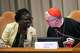 Vatican Secretary of State Cardinal Pietro Parolin, right, talks to theologian Leocadie Lushombo during the presentation of his first encyclical, "Magnifica humanitas: On Safeguarding the Human Person in the Time of Artificial Intelligence," at the Vatican, Monday, May 25, 2026.