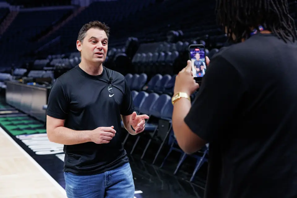 San Antonio Spurs content producer Rashad White, right, films a video of Spurs radio voice Dan Weiss talking to fans during the team’s shootaround practice at Target Center in Minneapolis, Friday, May 15, 2026, before Game 6 of the Western Conference semifinals against the Minnesota Timberwolves.