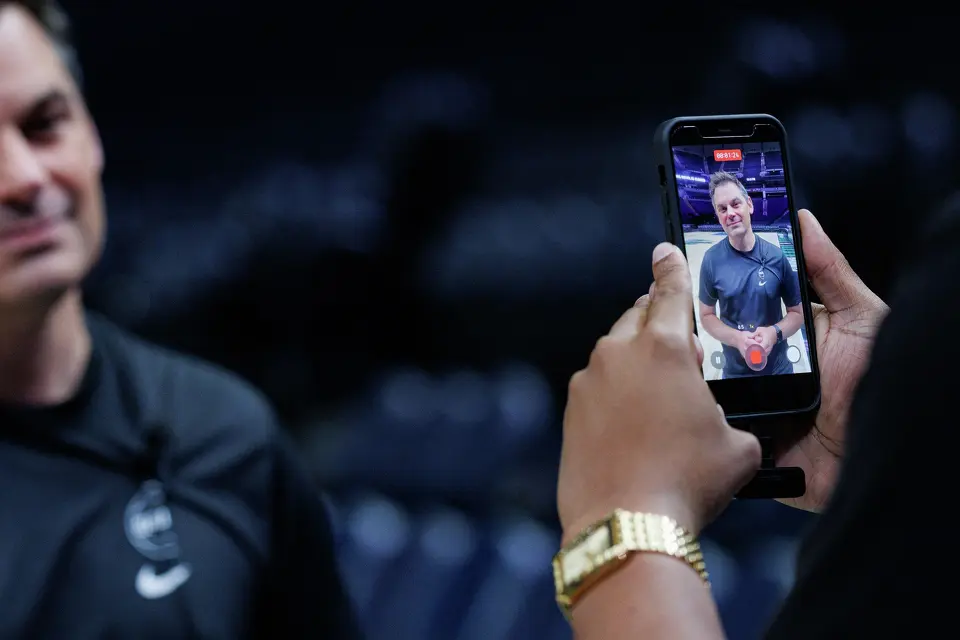 San Antonio Spurs content producer Rashad White, right, films a video of Spurs radio host Dan Weiss talking to fans during the team’s shootaround practice at Target Center in Minneapolis, Friday, May 15, 2026, before game six of the Western Conference semifinals against the Minnesota Timberwolves.
