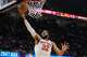 New York Knicks center Karl-Anthony Towns (32) shoots during the second half of Game 4 in the Eastern Conference finals NBA basketball playoffs series against the Cleveland Cavaliers in Cleveland, Monday, May 25, 2026.