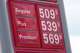 The per-gallon prices for the various grades of gasoline available at a gas station are displayed on a sign above the pumps, Sunday, May 24, 2026, in southeast Denver.