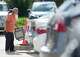 A poll worker carries a voting machine to a vehicle for curbside voting outside the Sunnyside Multi-Service Center during the primary runoff election in Houston Tuesday, May 26, 2026.