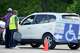 A poll worker carries a voting machine to a vehicle for curbside voting outside the Sunnyside Multi-Service Center during the primary runoff election in Houston Tuesday, May 26, 2026.
