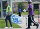 A poll worker carries a curbside voting machine back inside at the Sunnyside Multi-Service Center during the primary runoff election in Houston Tuesday, May 26, 2026.