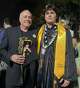 Hunter Metcalf, pictured with his father, Jeff Metcalf, accepted his twin's posthumous diploma from Memorial High School.
