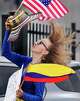 Colombia Aya-Rosillo holds onto her hat in the wind while campaigning for Colombia’s presidential election outside the West Gray Metropolitan Multi-Service Center in Houston Tuesday, May 26, 2026. The center is hosting voting for both the Texas primary runoff election and Colombia’s presidential election, where registered Colombian citizens can vote through Sunday.