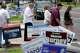 People cross the street among campaign signs outside the West Gray Metropolitan Multi-Service Center, a polling site for the Texas primary runoff election, in Houston Tuesday, May 26, 2026.