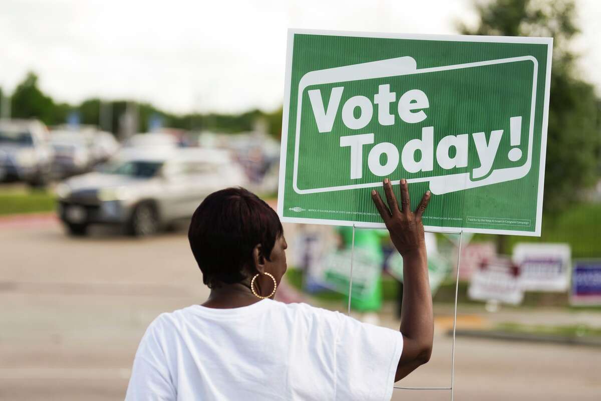 A political supporter holds up a sign that reads “Vote Today” across from the Sunnyside Health and Multi-Service Center on Election Day in Houston, Tuesday, May 26, 2026.