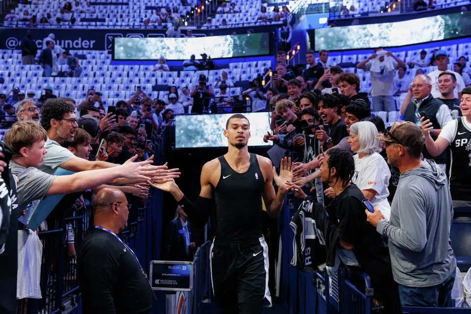 San Antonio Spurs center Victor Wembanyama slaps hands with fans as he runs onto the court to warm up before Game 5 of the Western Conference Finals against the Oklahoma City Thunder at Paycom Center in Oklahoma City, Tuesday, May 26, 2026.