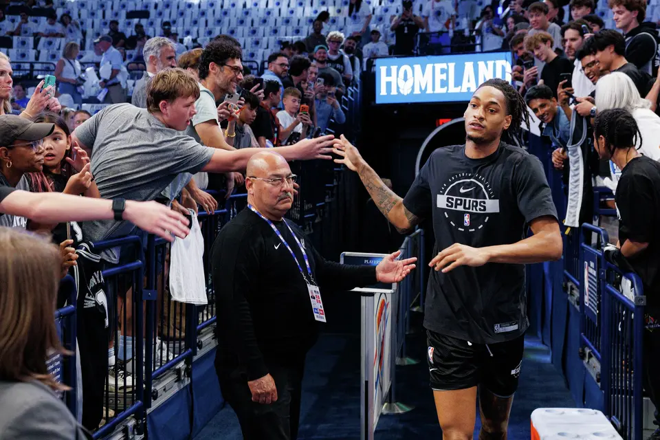 San Antonio Spurs guard Devin Vassell slaps hands with fans as he runs onto the court for warmups before Game 5 of the Western Conference Finals against the Oklahoma City Thunder at Paycom Center in Oklahoma City, Tuesday, May 26, 2026.